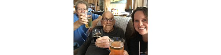 Alyson and her parents, toasting to the camera with beers in hand.